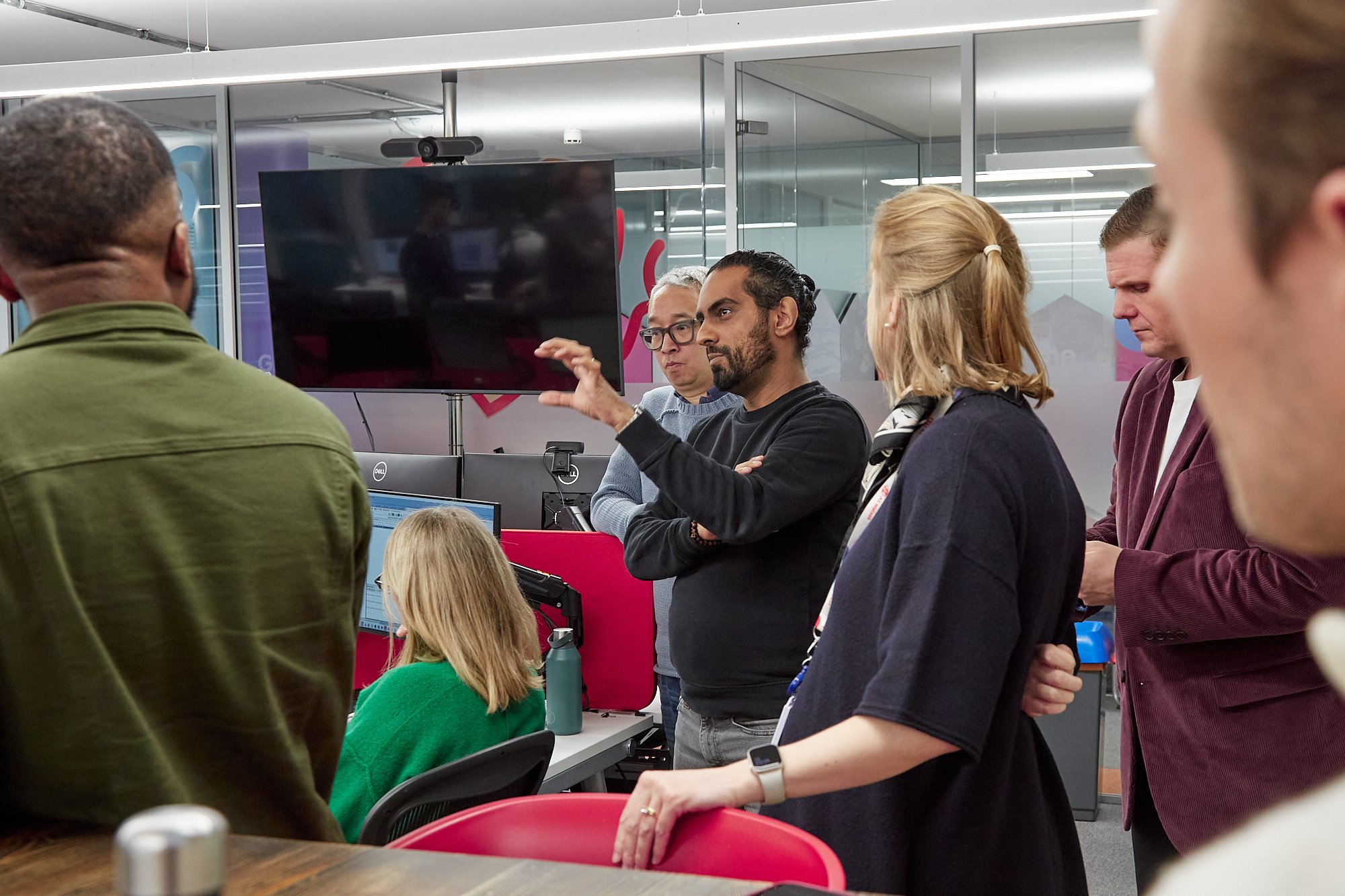 People in an office setting, discussing data.