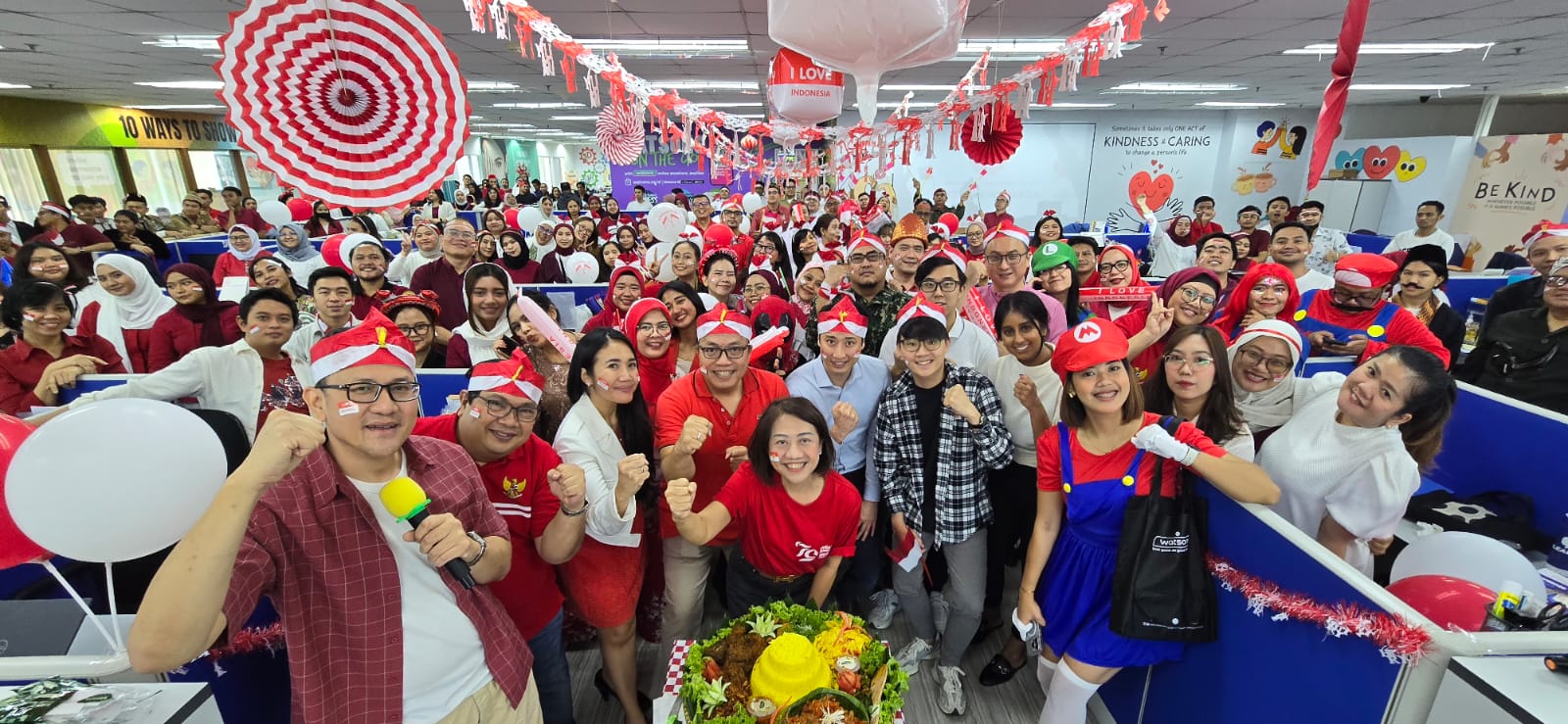 Group of people celebrating with red and white decorations.