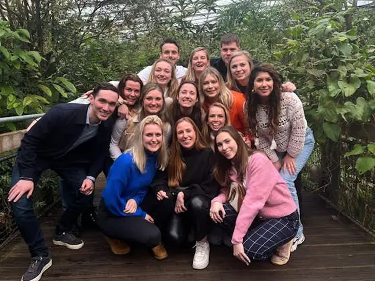 Group of people posing together outdoors.