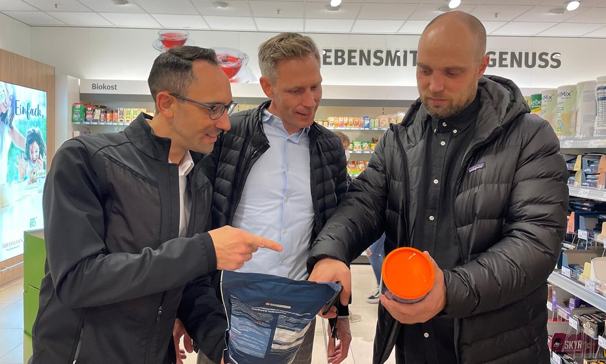 Three men looking at products in a store.