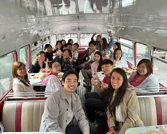 People on a bus, smiling and eating.