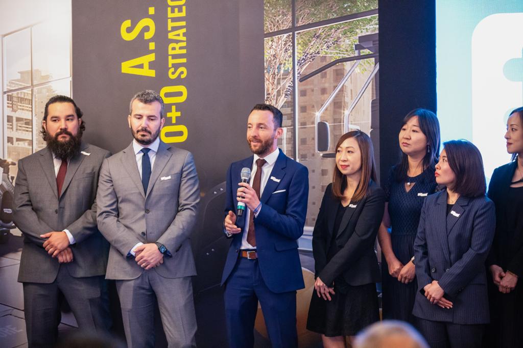 Group of people in suits at a presentation.