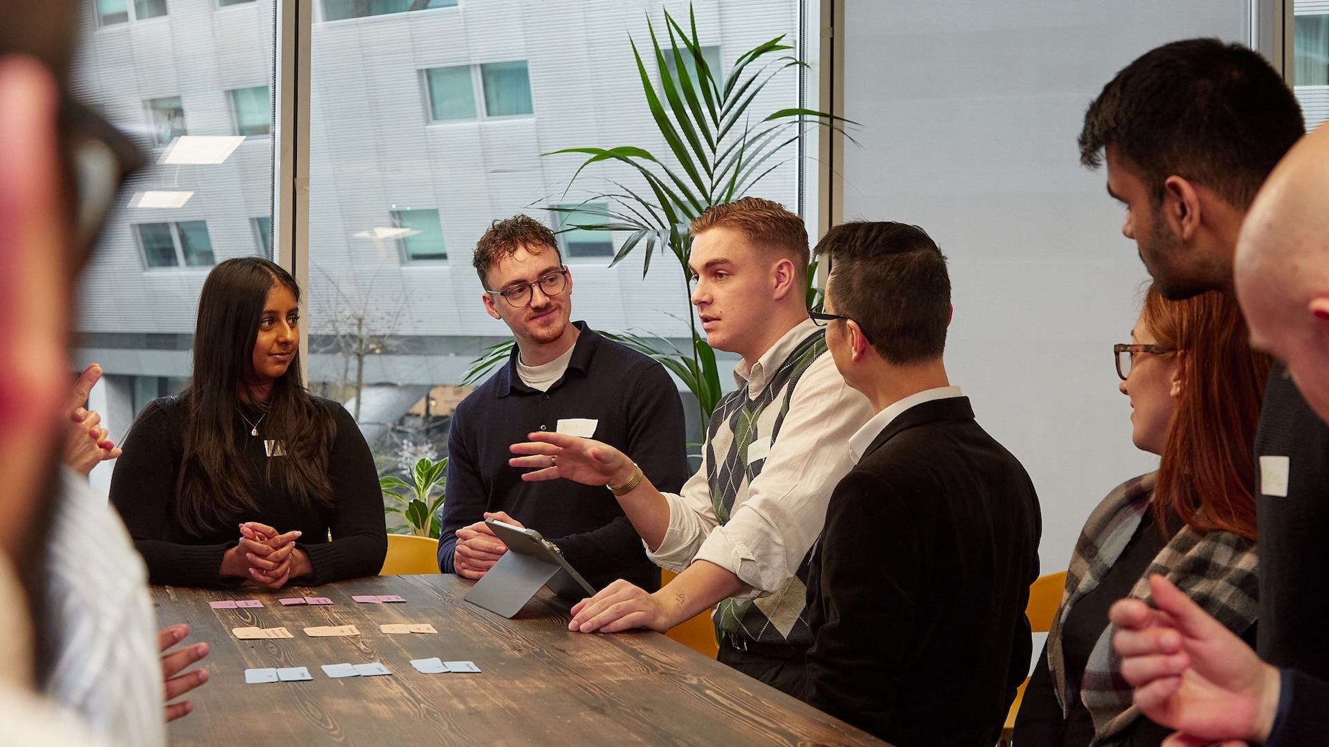 Group of people in a meeting, discussing ideas.