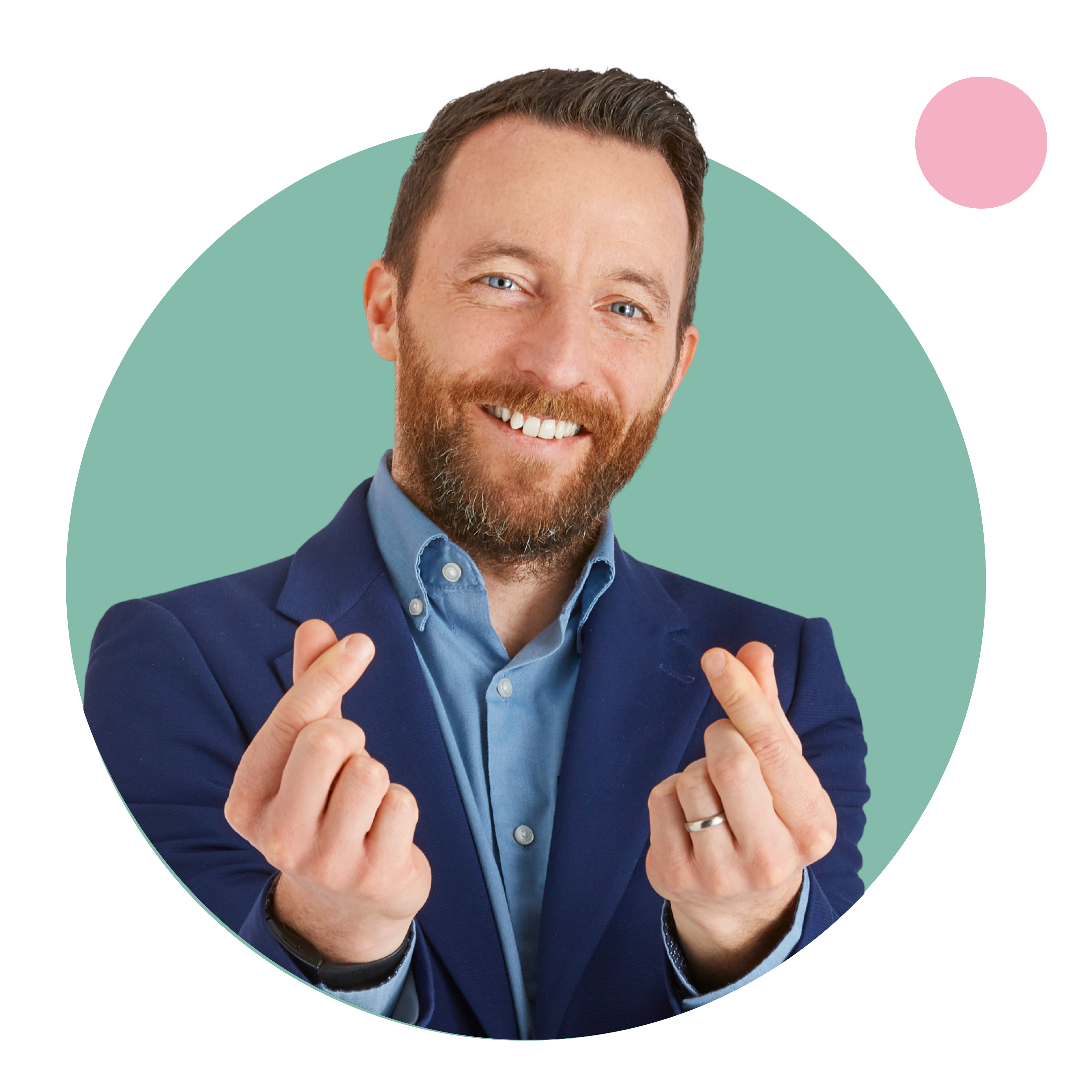 Man in blue suit making a heart sign with hands.